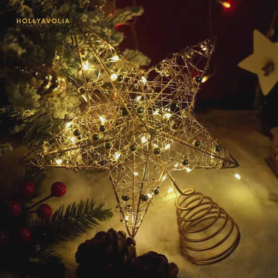 Light-up star tree topper glowing on a Christmas tree